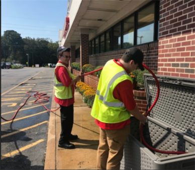 Students working outside at a commercial establishment.